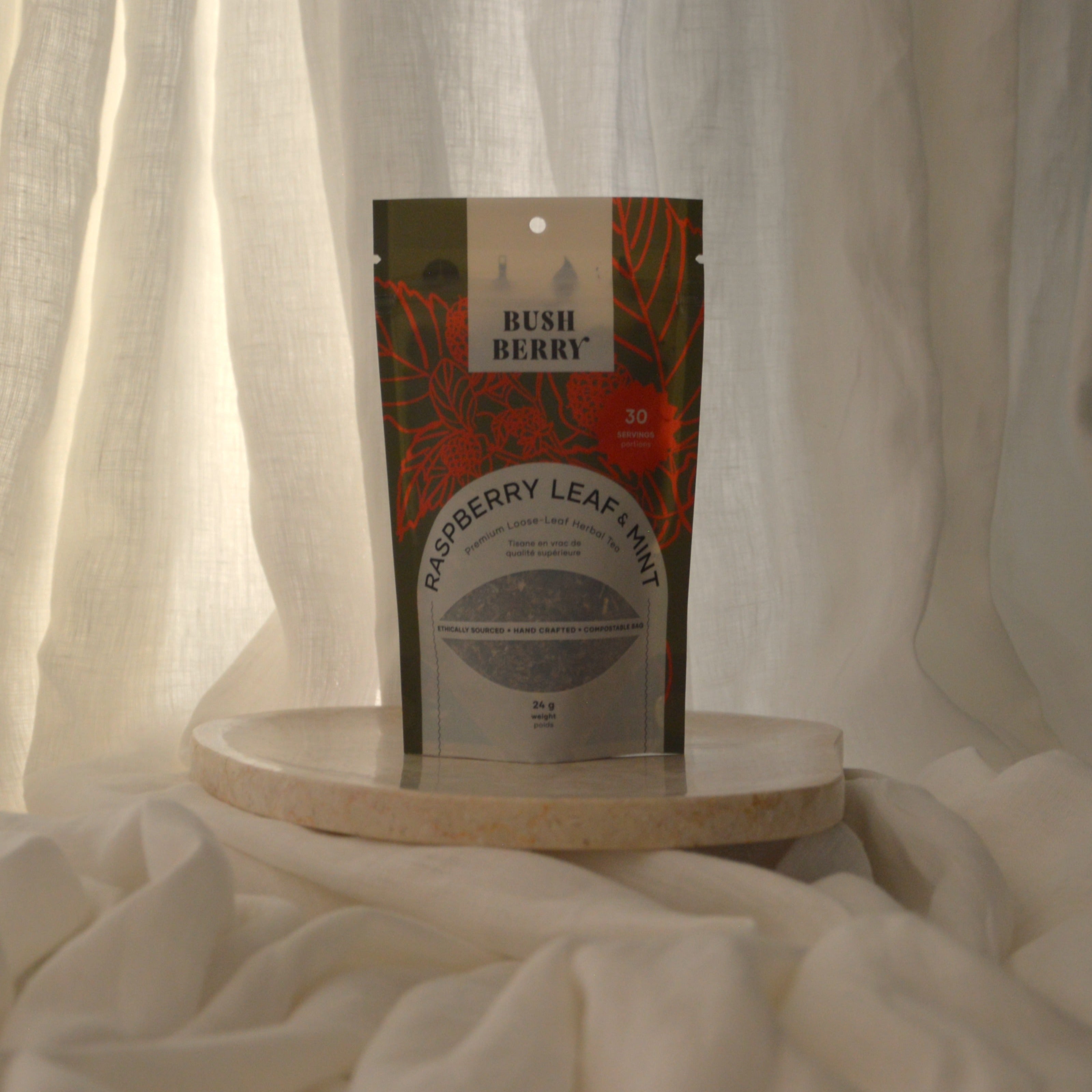 Rush Berry raspberry leaf mix package on a white surface with a white curtain background